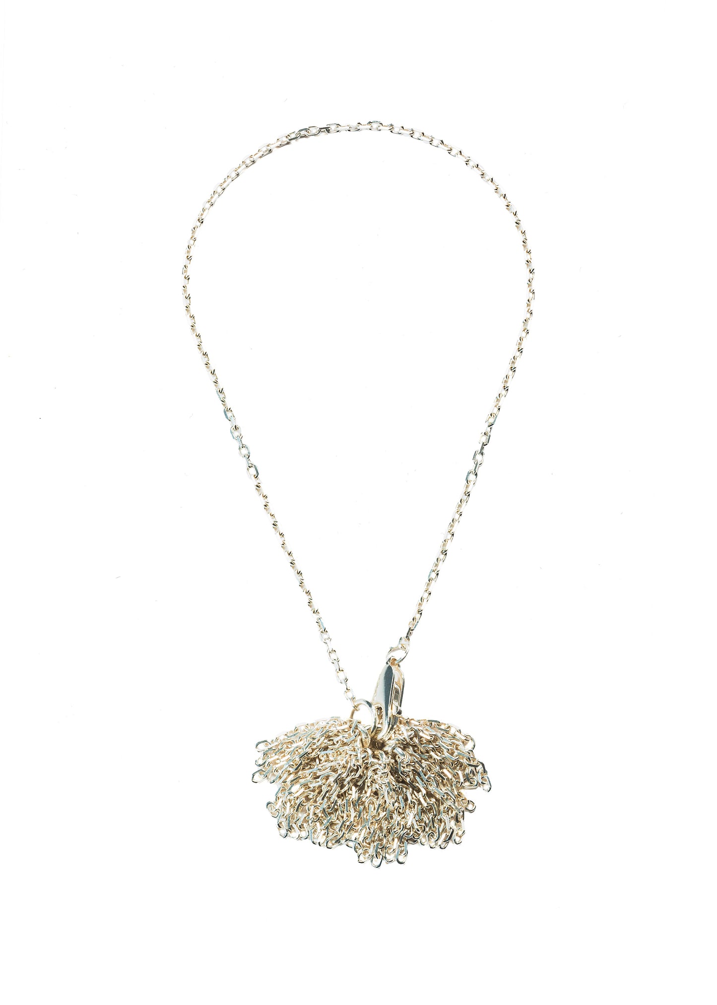 A sterling silver bracelet with a pom pom charm attached to the clasp, displayed against a white background, made by Bird