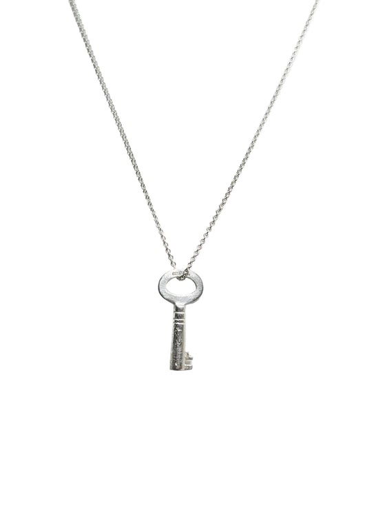 Silver key pendant necklace on a white background